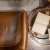 leather chairs and table top with books and a tea cup on saucer