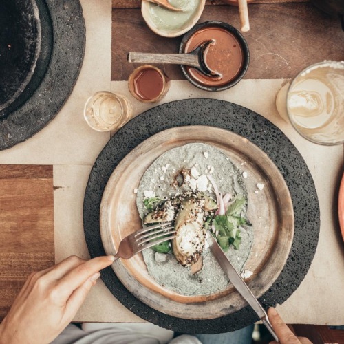people around a table of food