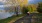 a man riding a bicycle on a path next to a river