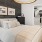 a bedroom with a bed and a lamp