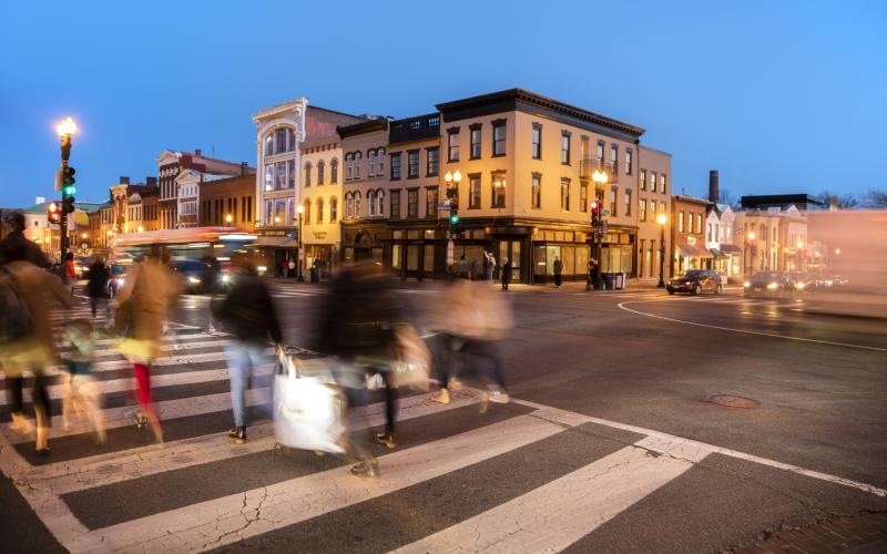 A beautiful community at the heart of all your passions a group of people crossing a street